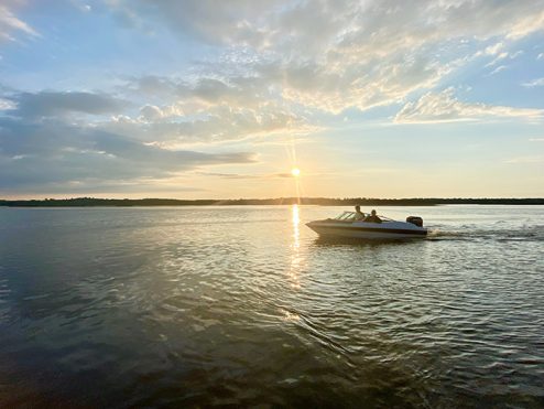 boat at sunset on pigeon lake